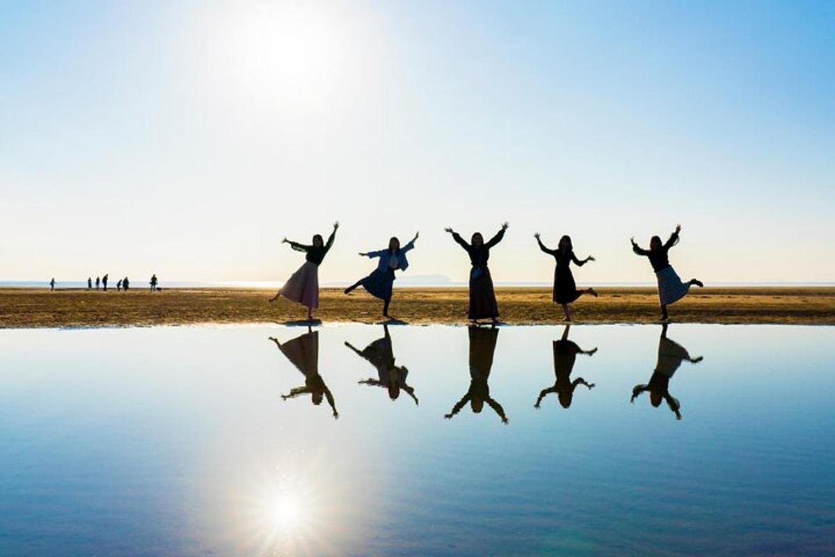 a group of people jumping in the water