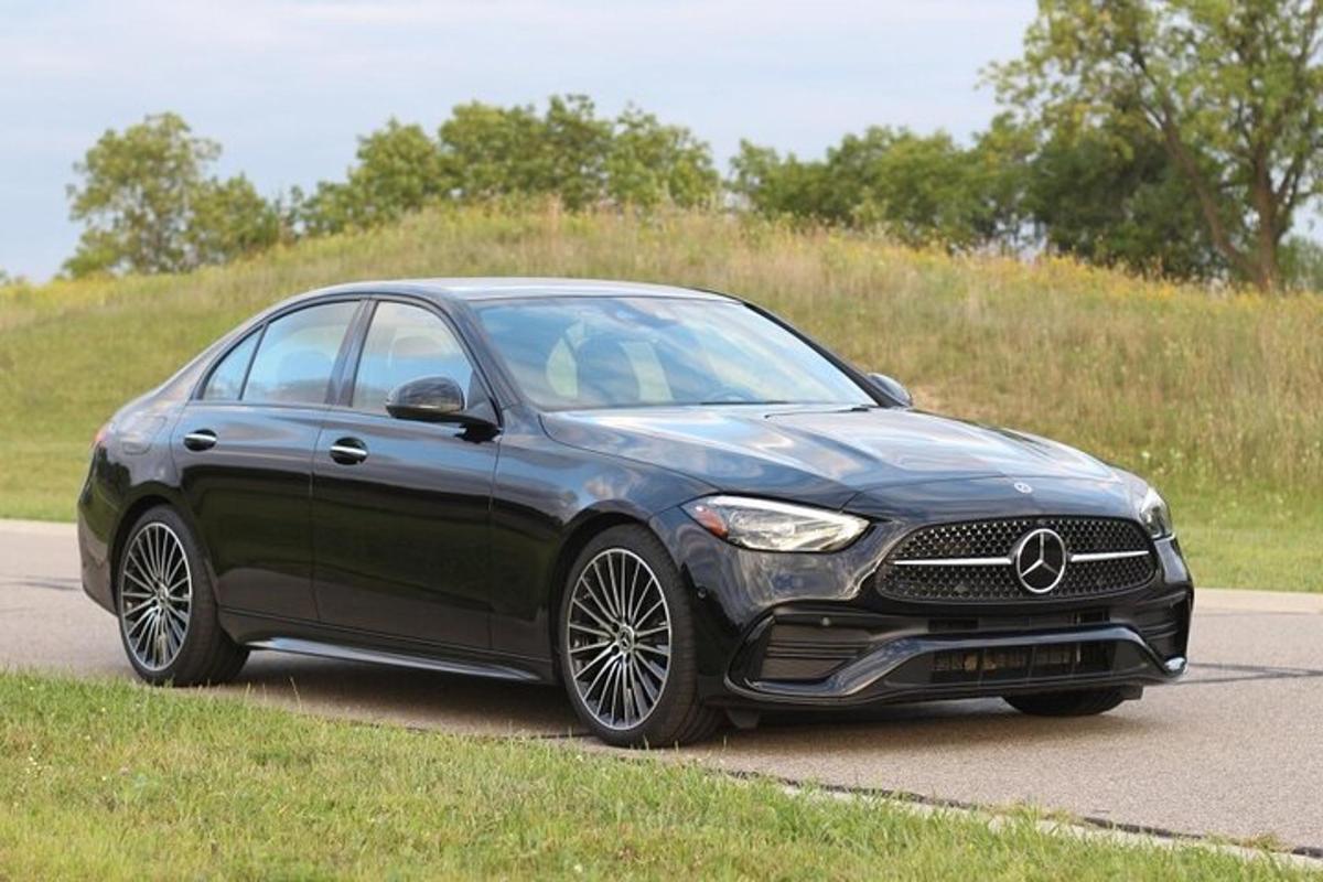 a black mercedes benz car parked on a road