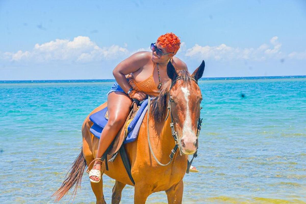 a woman riding a horse on the beach