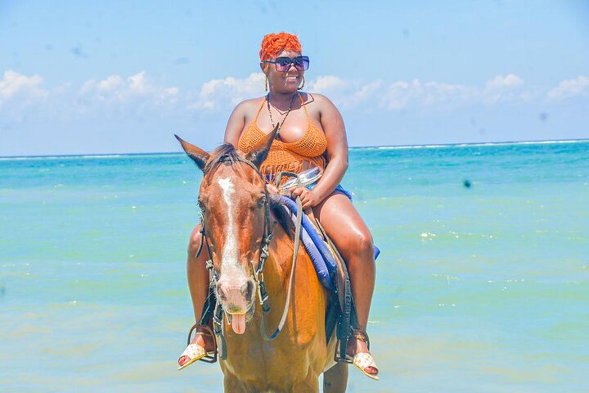 a woman riding a horse on the beach