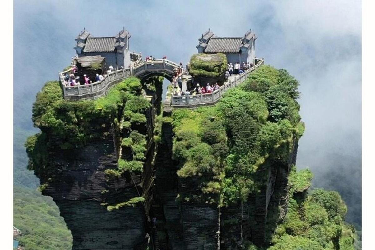 a group of people standing on top of a mountain