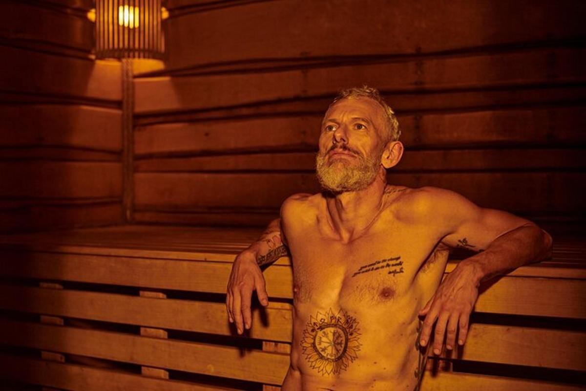 un uomo senza maglietta in piedi in una sauna