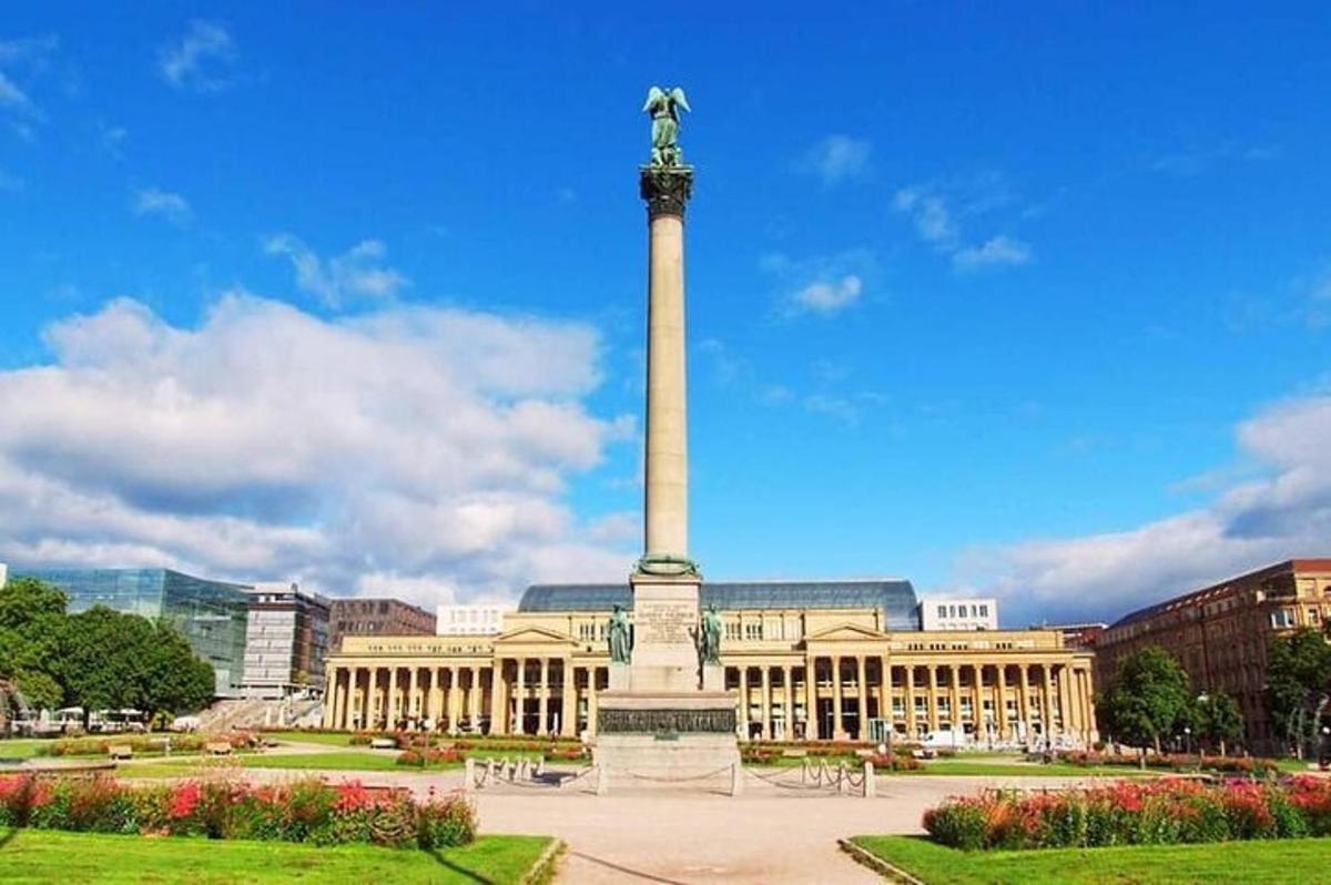 a large building with a monument in front of it