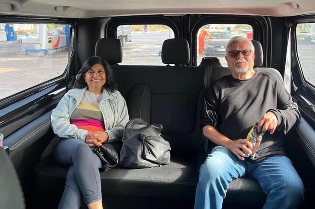 a man and a woman sitting in the back of a van