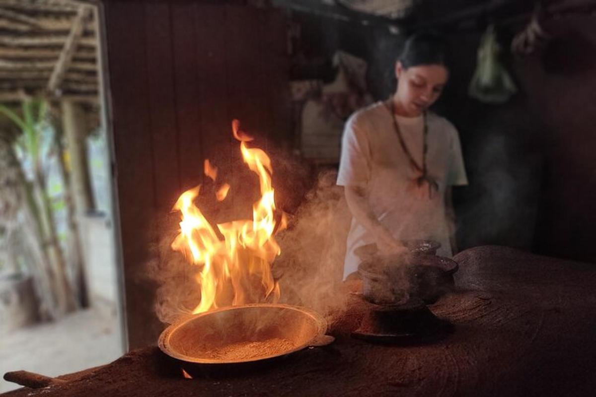a woman cooking food on a grill with fire
