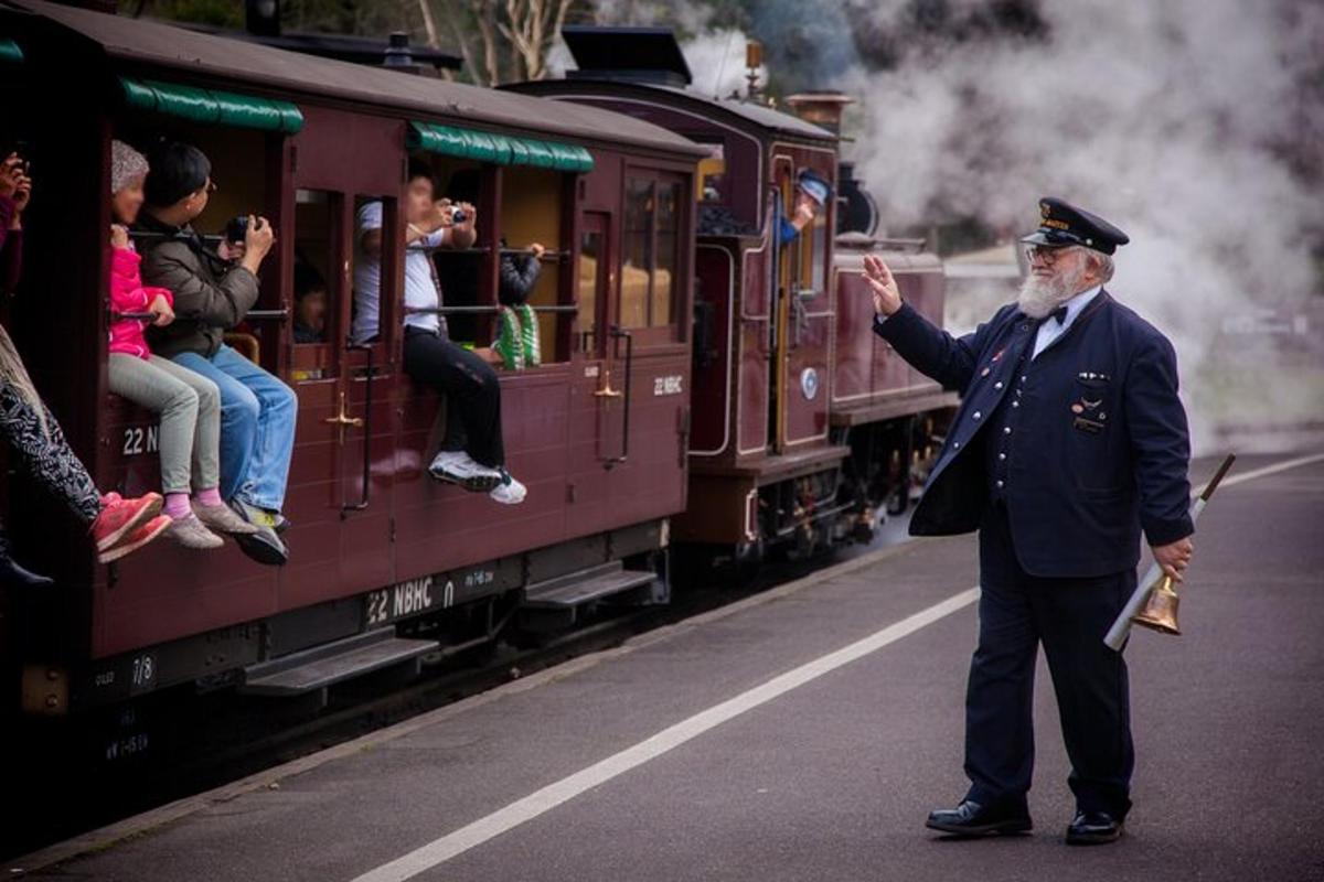 a man in uniform standing next to a train