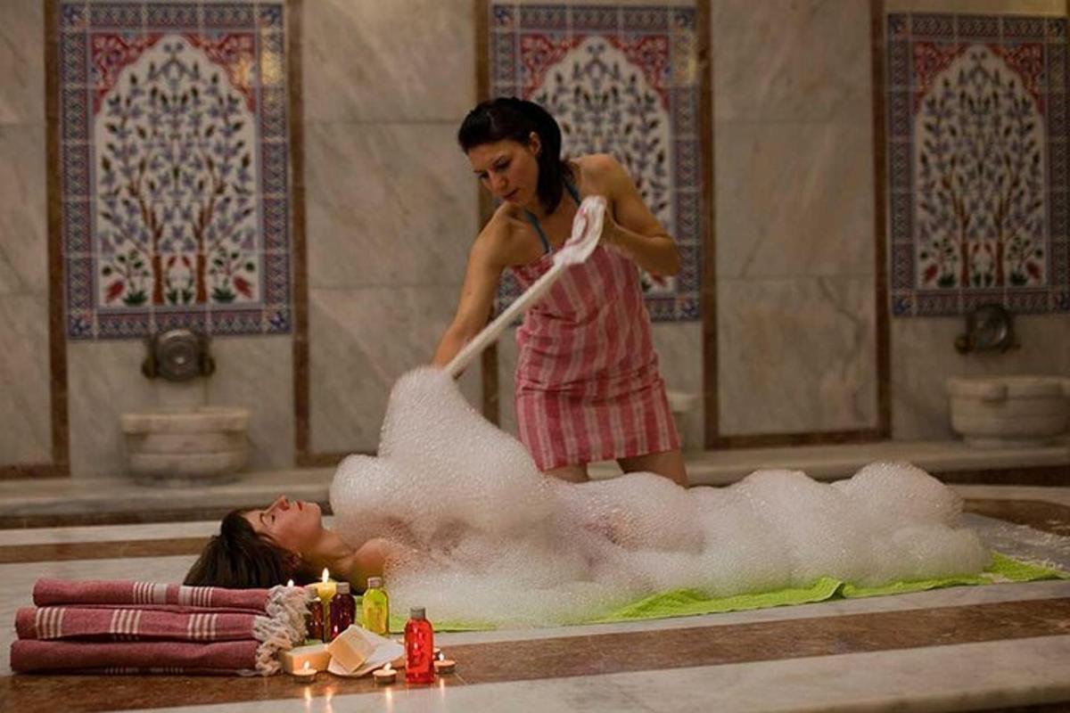 a woman isblocking a woman in a bath tub