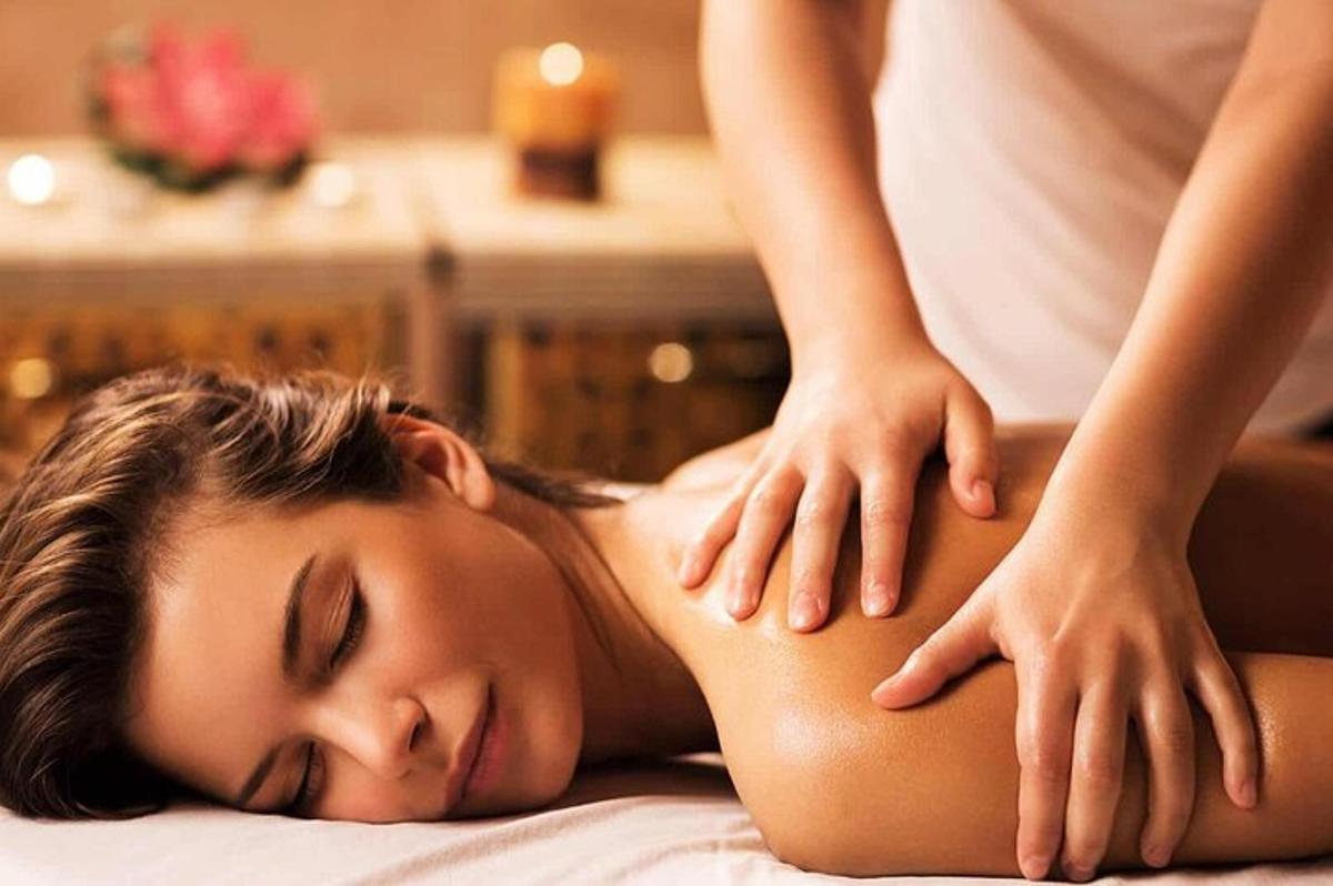 a woman getting a back massage from a therapist