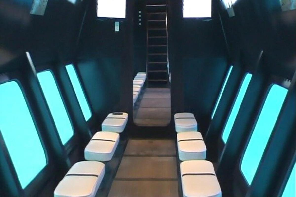 a group of toilets in a room with windows
