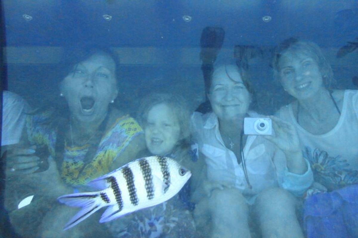a group of people taking a picture with a fish