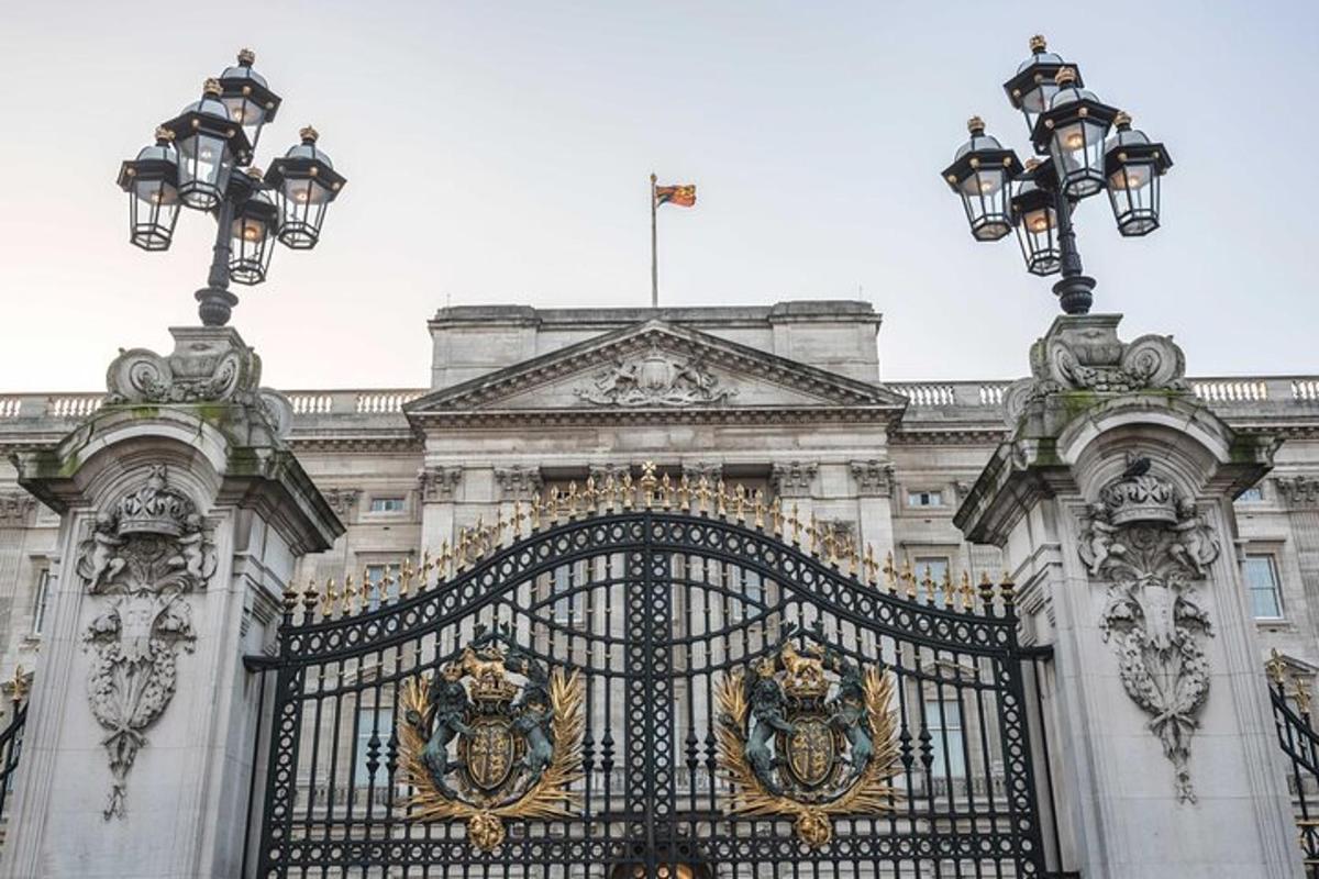 a gate in front of a building with a flag on top