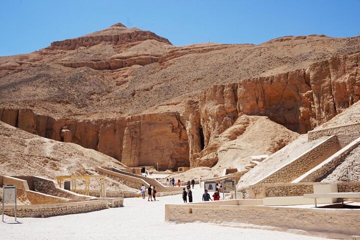 a group of people walking through a desert canyon