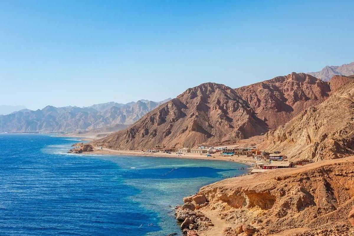 a view of a beach with mountains in the background