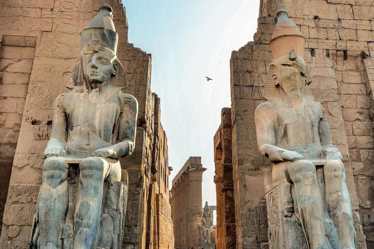 two large statues standing in front of a building