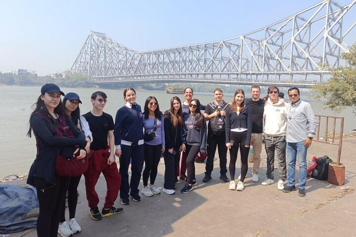 a group of people standing in front of a bridge