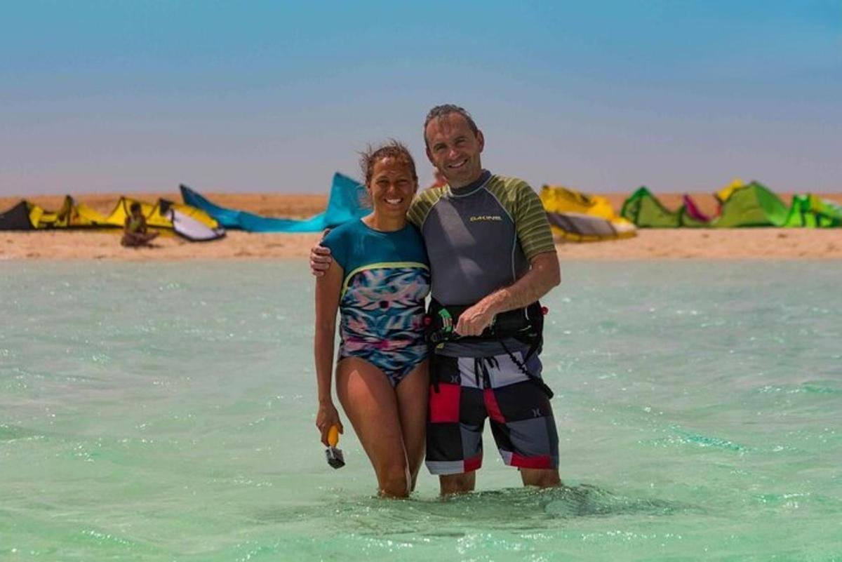 a man and a woman standing in the ocean
