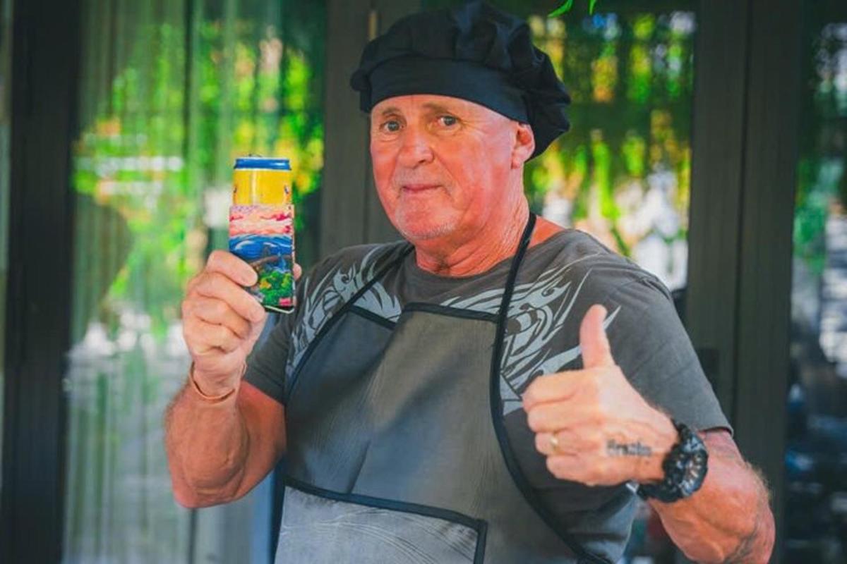 a man giving a thumbs up while holding a cell phone