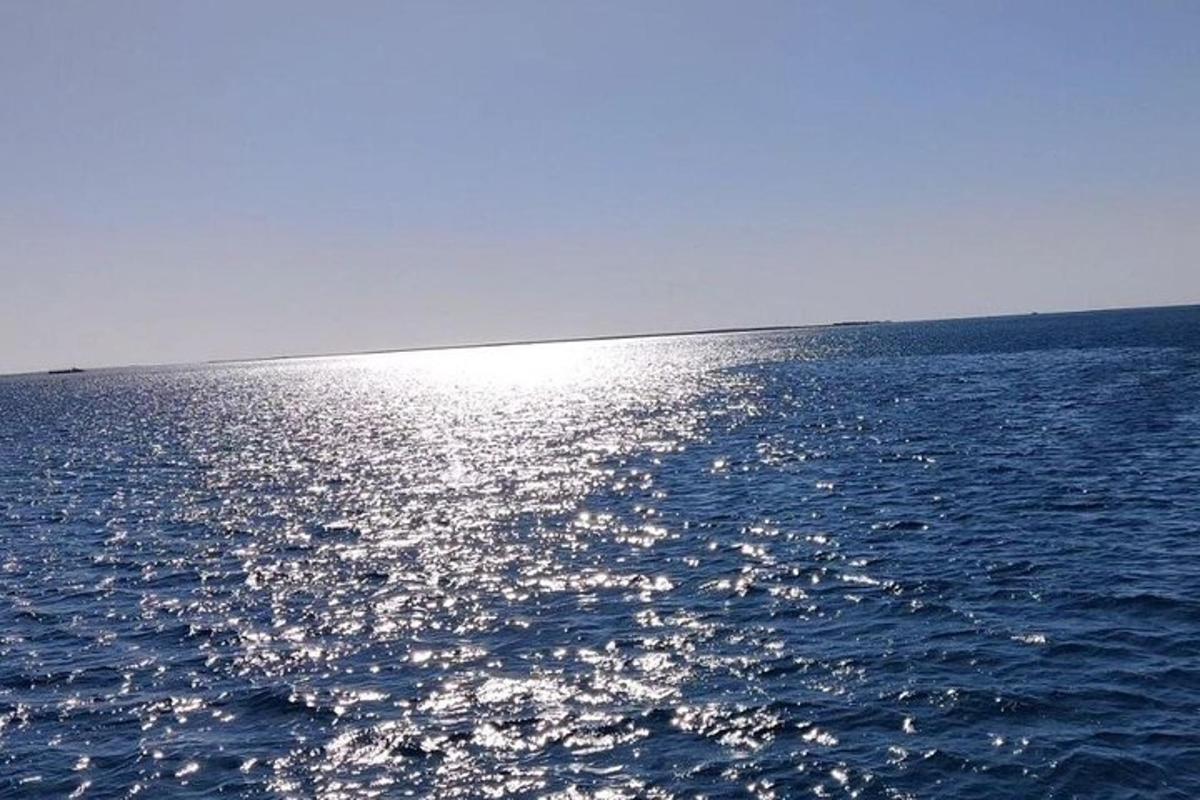en stor vannmasse med solen som reflekteres på den