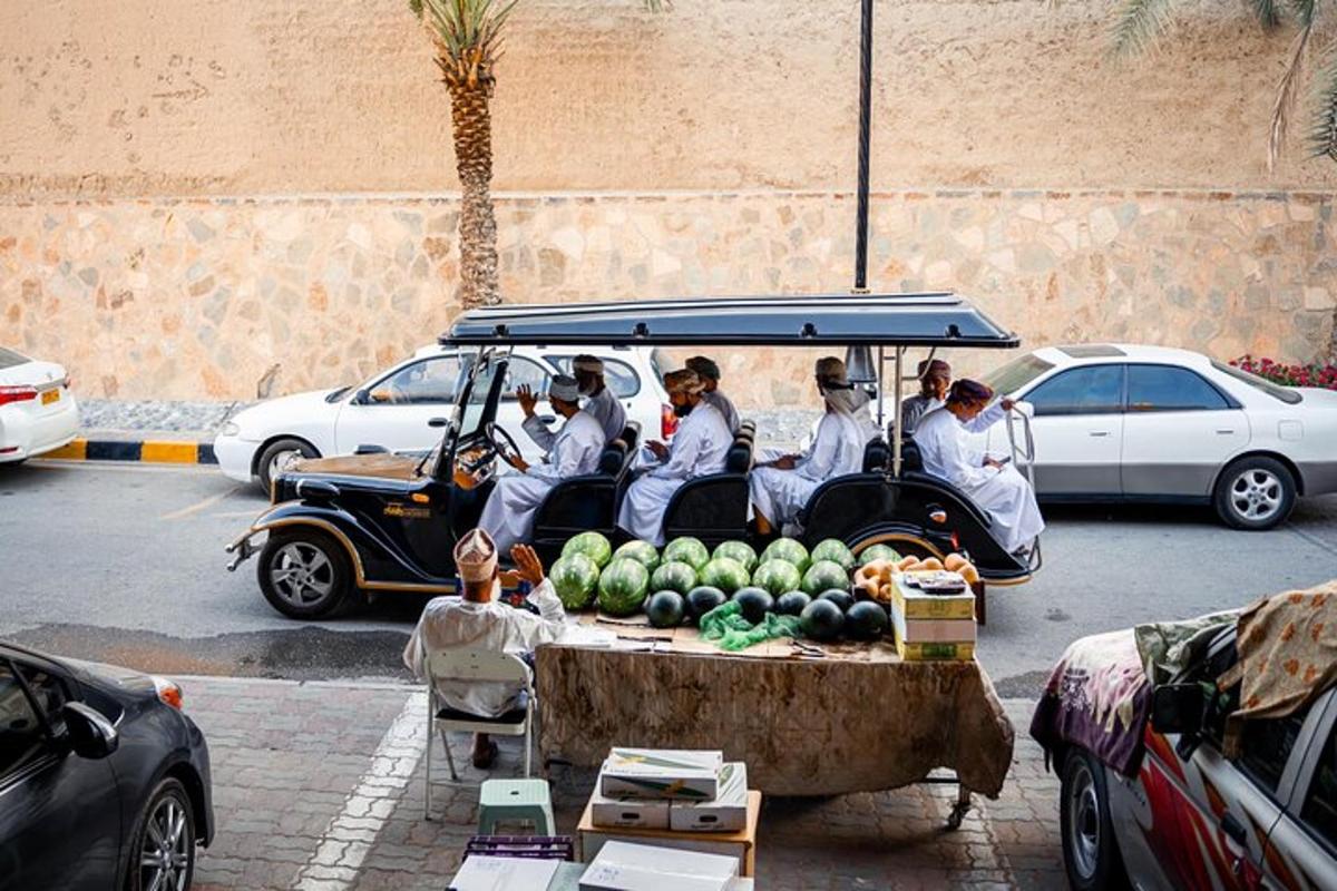 a group of people in a golf cart with fruit