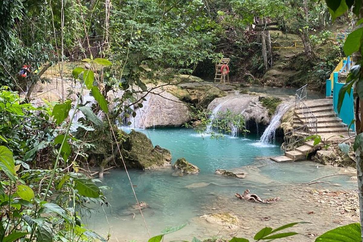 a pool of water in front of a waterfall