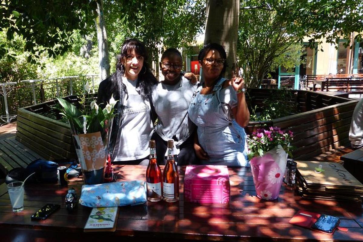 three women standing next to a picnic table