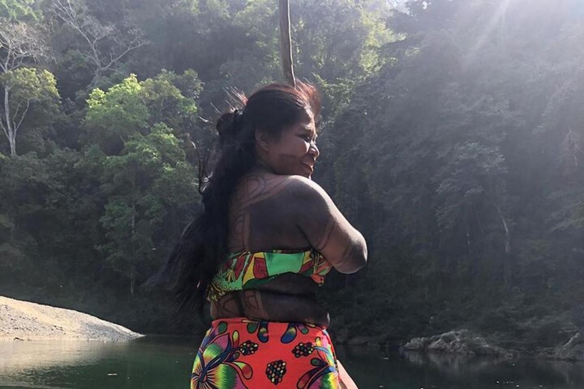 una donna in piedi davanti a uno specchio d'acqua