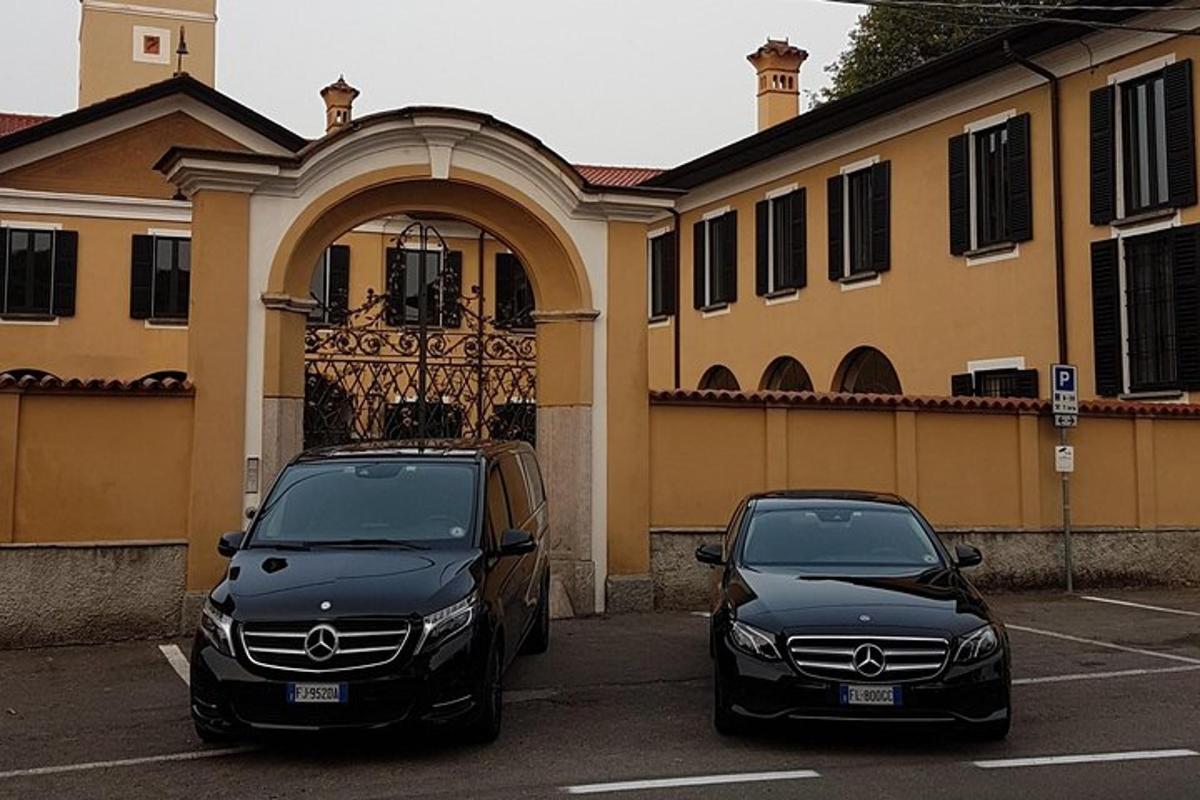 dwa samochody zaparkowane na parkingu przed budynkiem