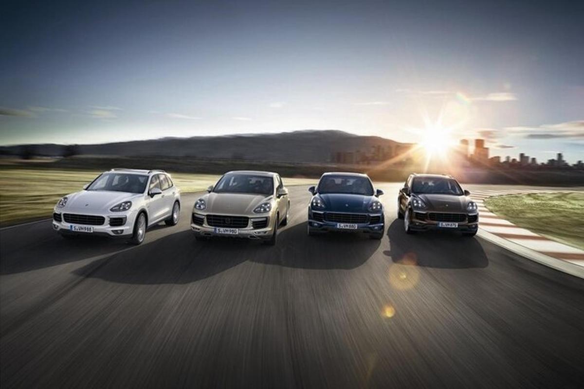 a group of four cars driving down a road