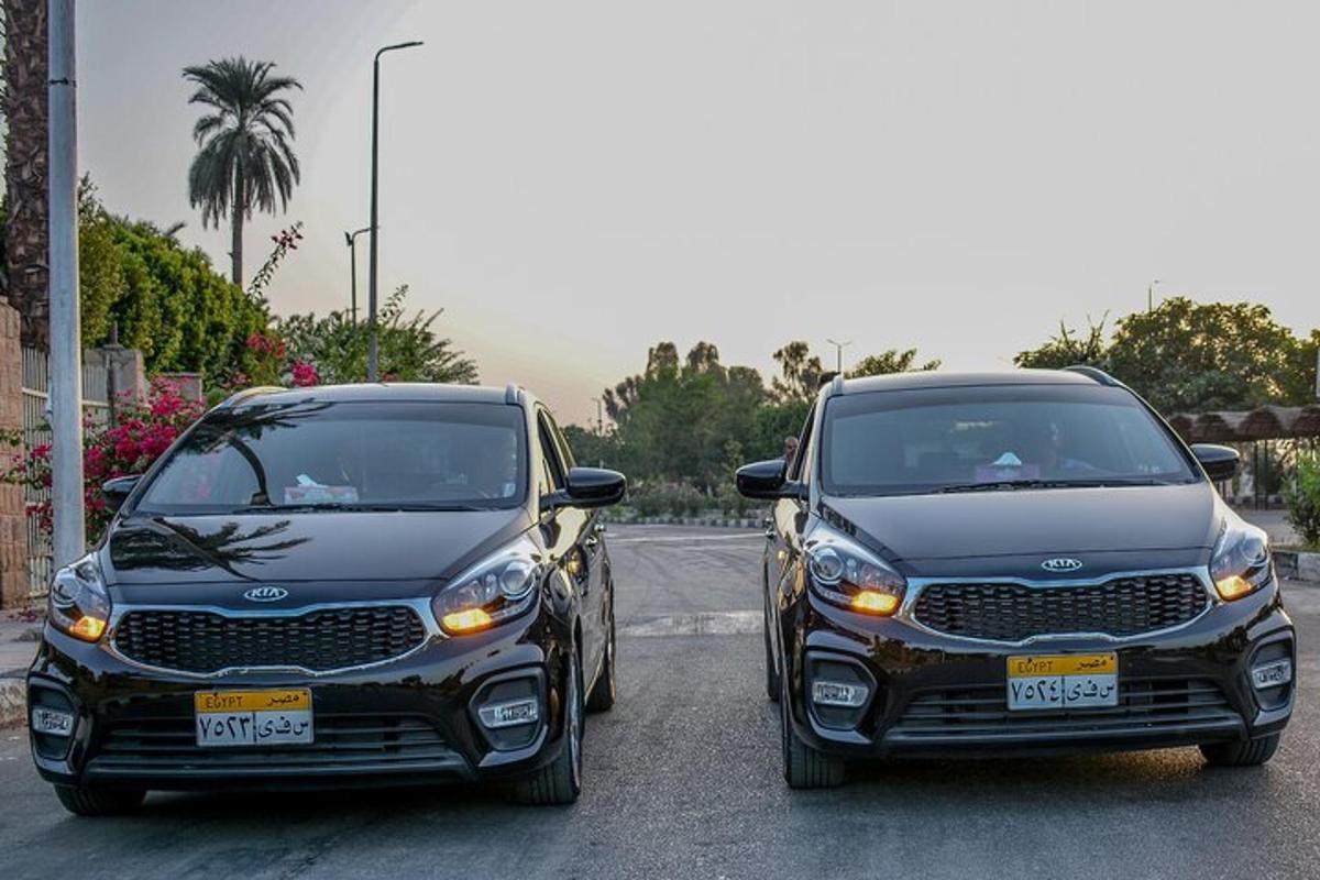 two black cars parked next to each other on a street