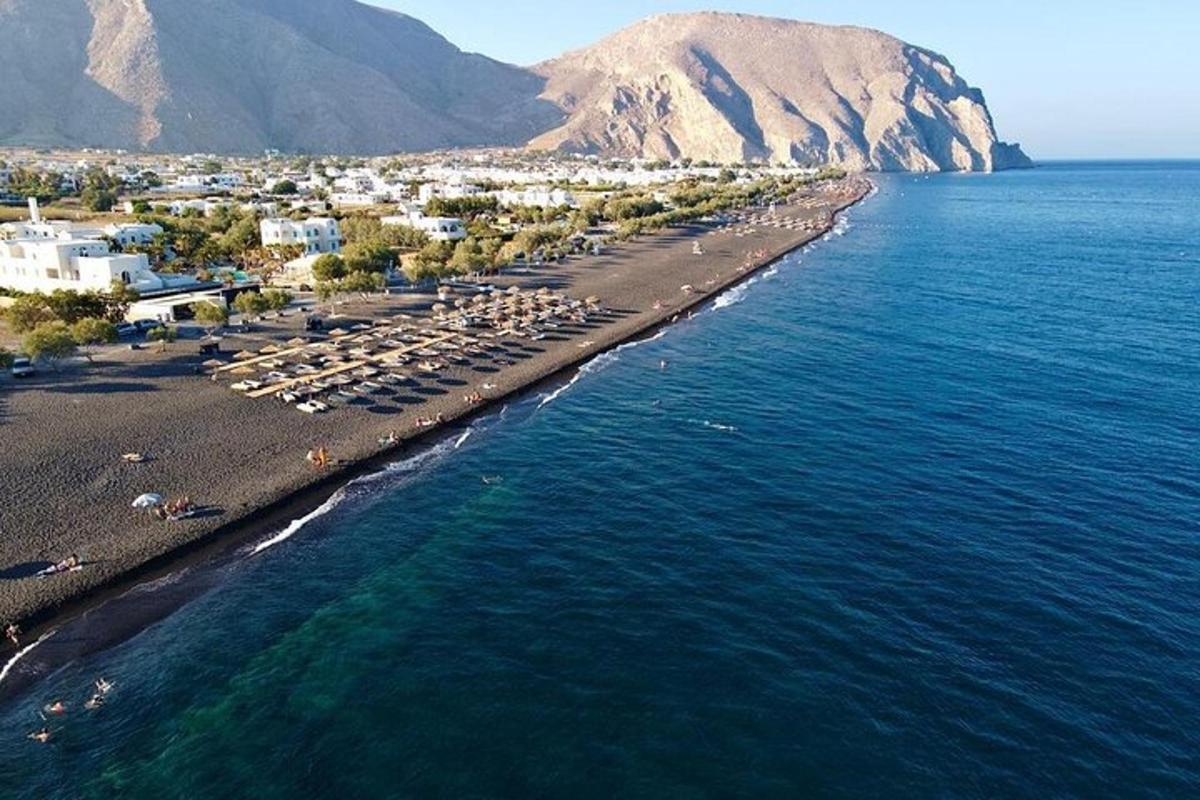 an aerial view of a beach with buildings and the water