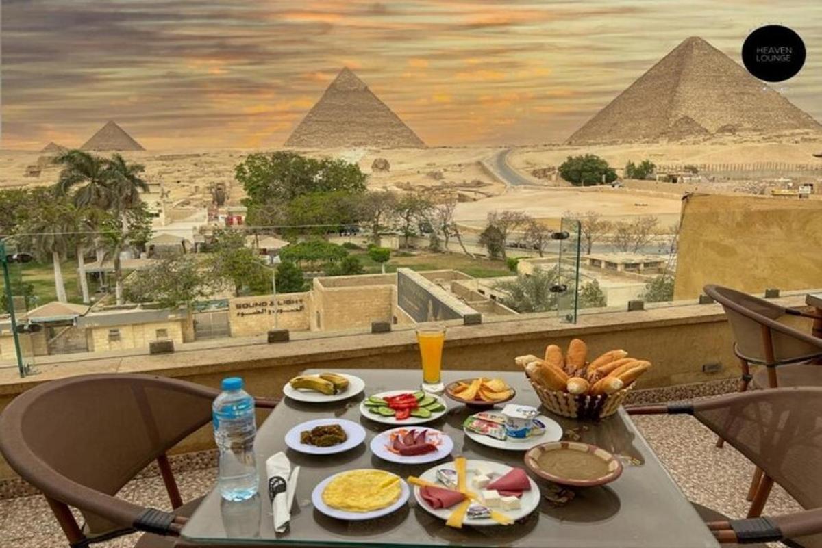 a table with food on it with a view of the pyramids