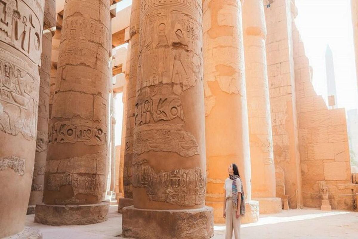 uma mulher em pé em um templo com colunas