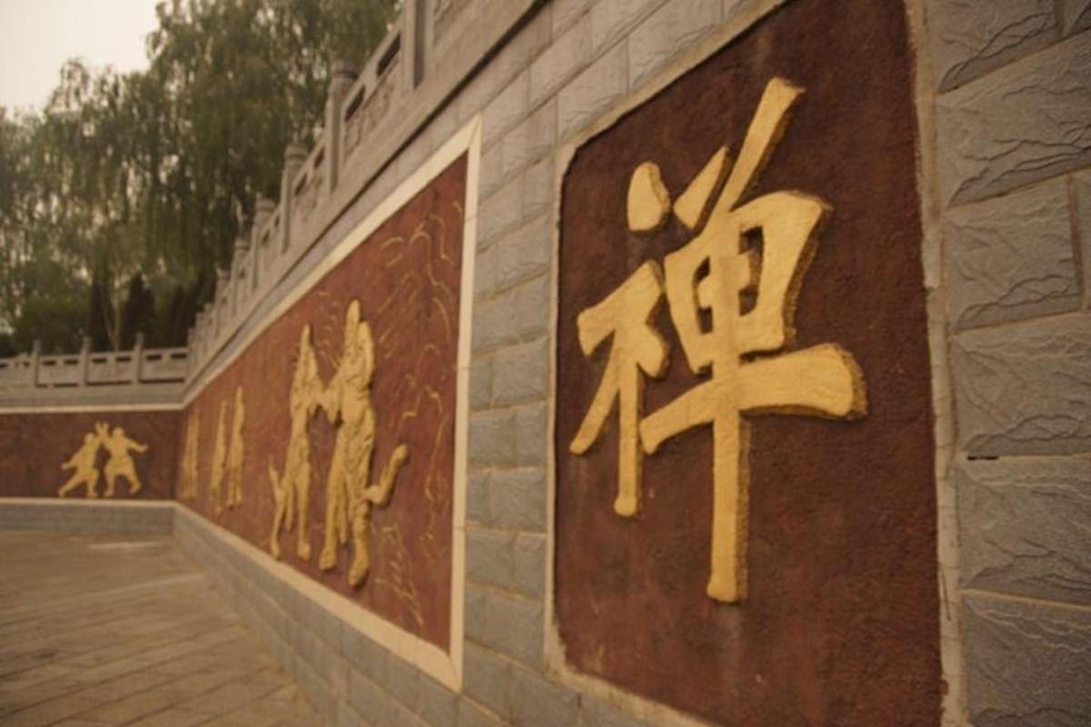 a wall with chinese writing on the side of a building
