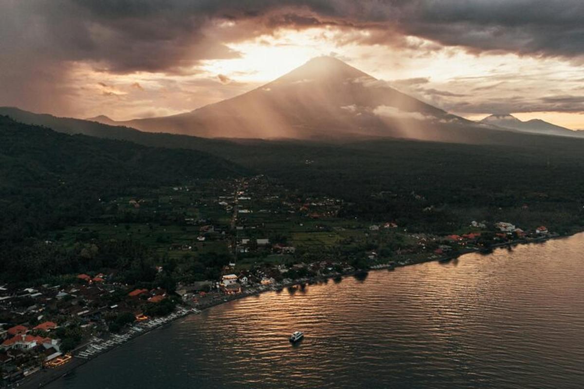 an aerial view of a lake with a mountain