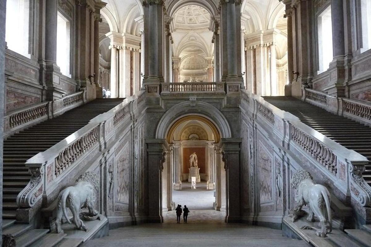 two people standing in a large building with statues