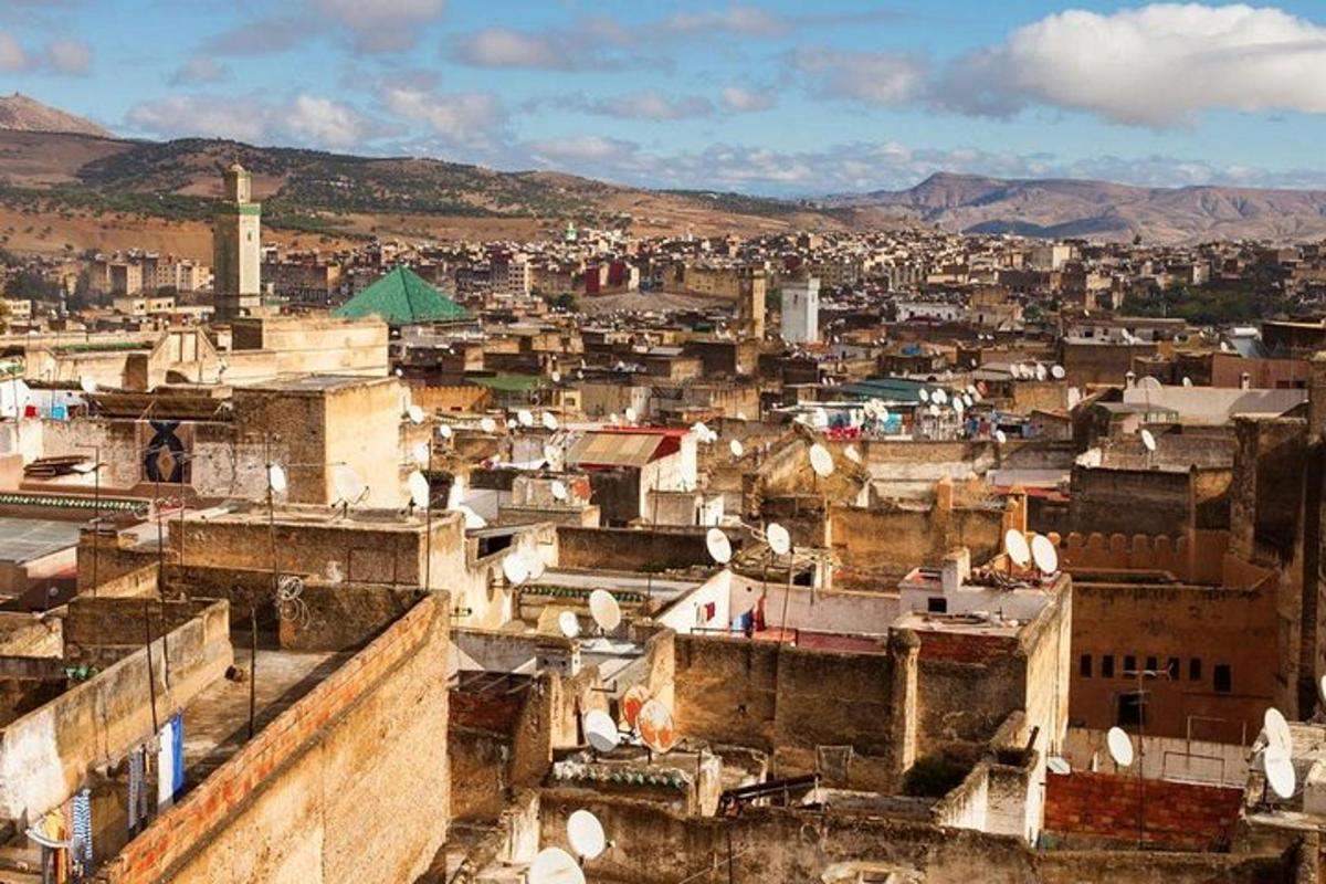 a view of a city with buildings and mountains