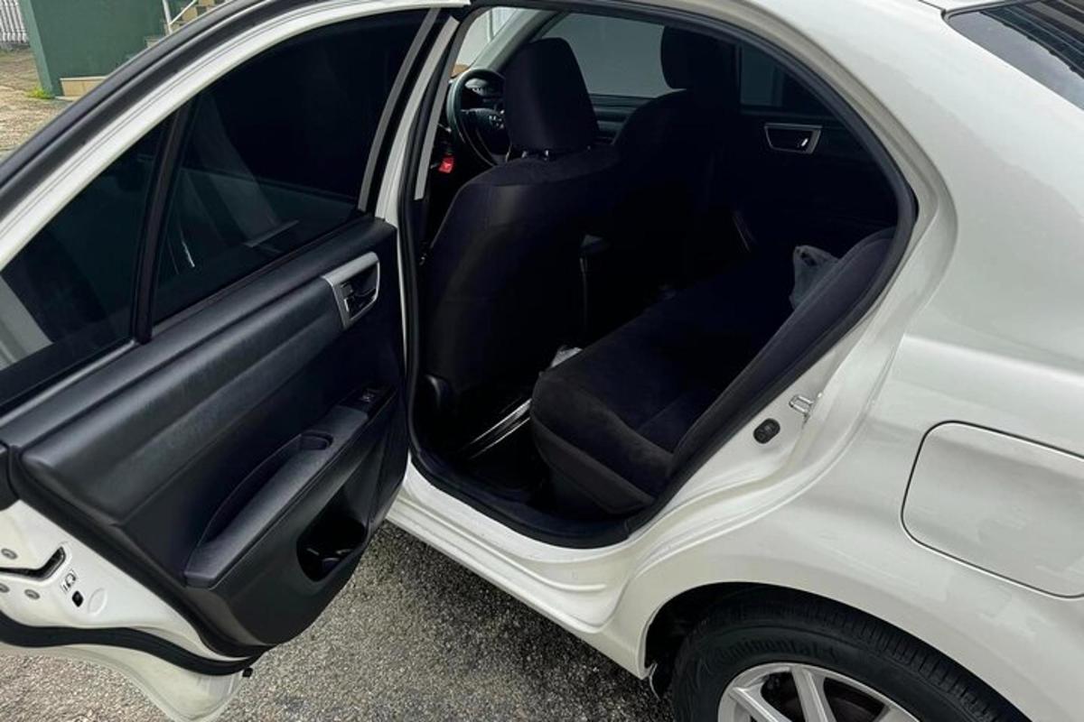 a white car with its door open in a parking lot