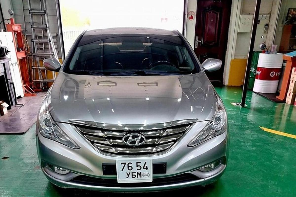 a silver car is parked in a garage