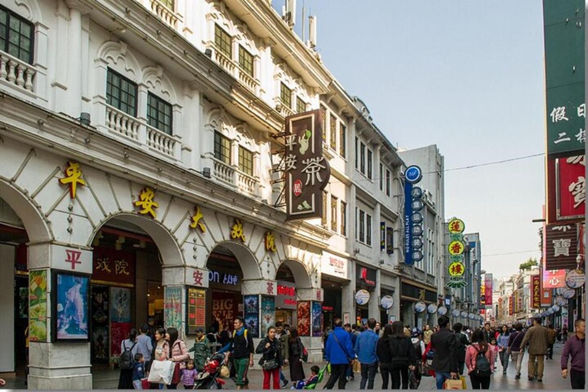 a crowd of people walking down a busy city street