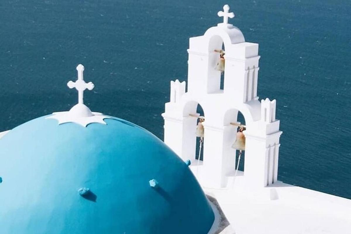 a white chapel with two people standing on top of it