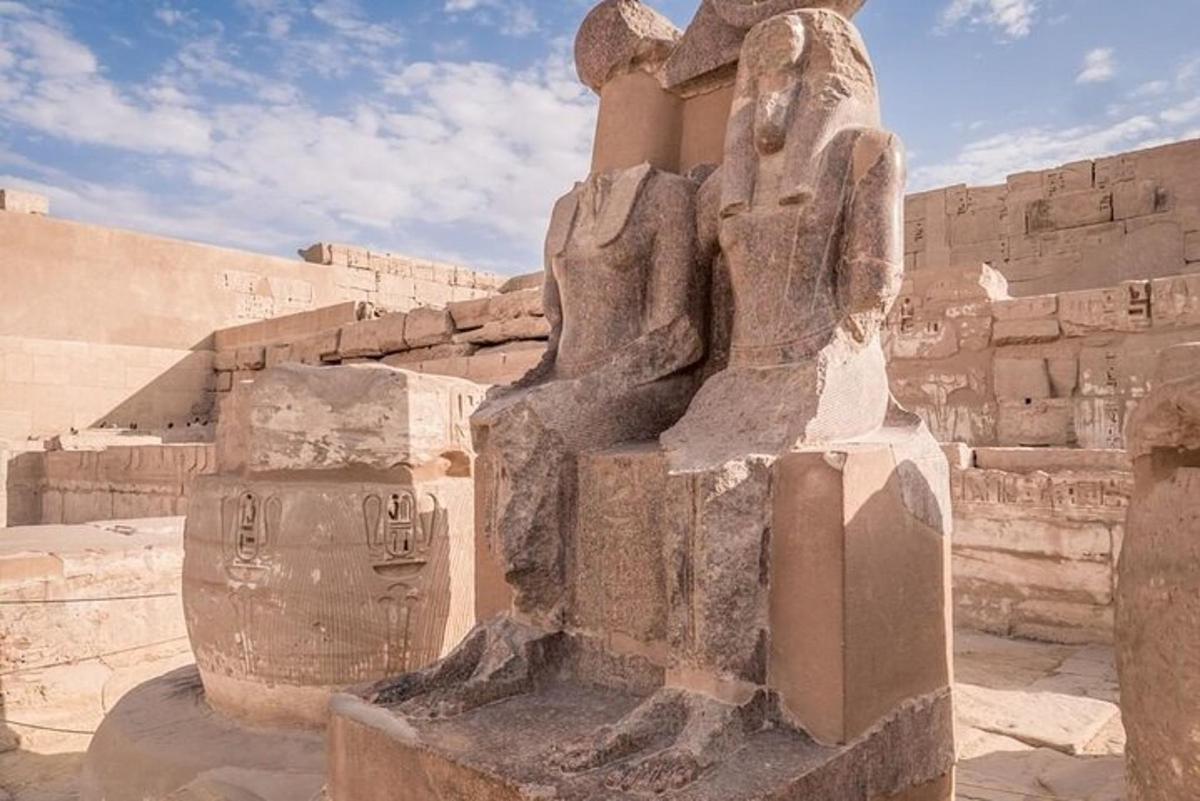 a statue in front of a stone building