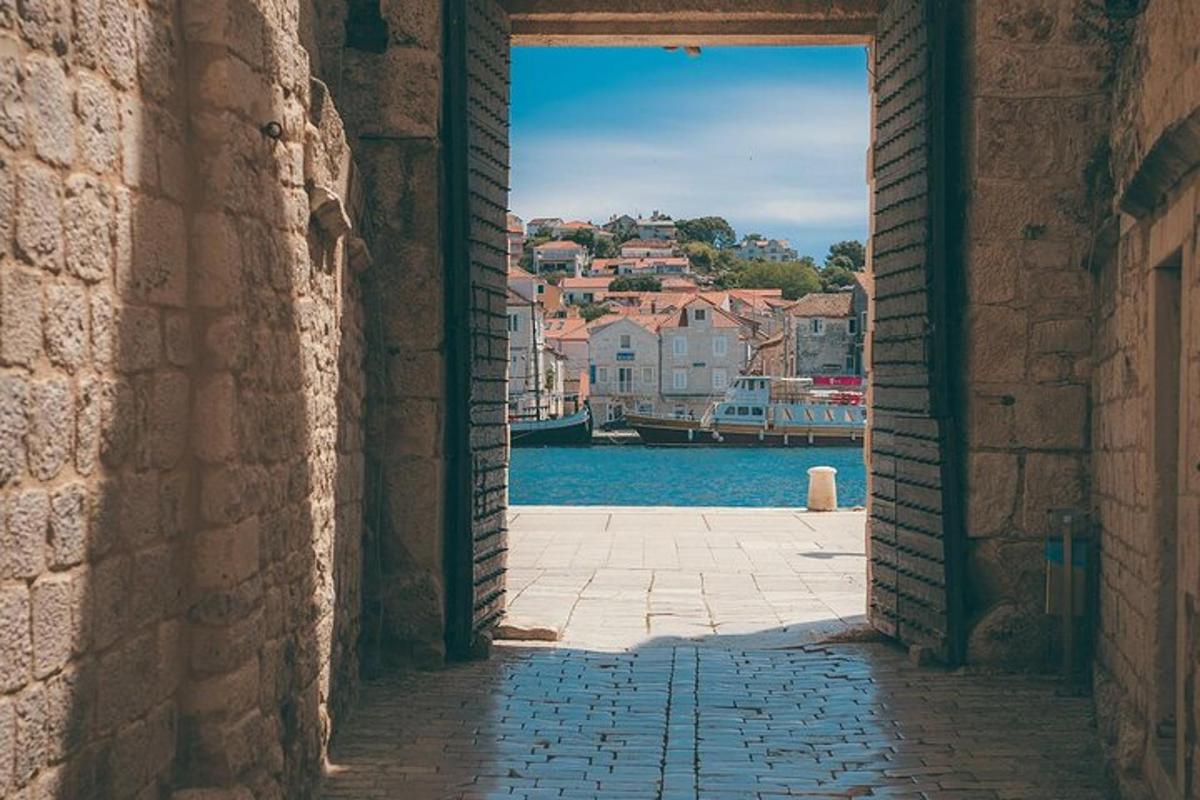 an alleyway with a view of a river and buildings