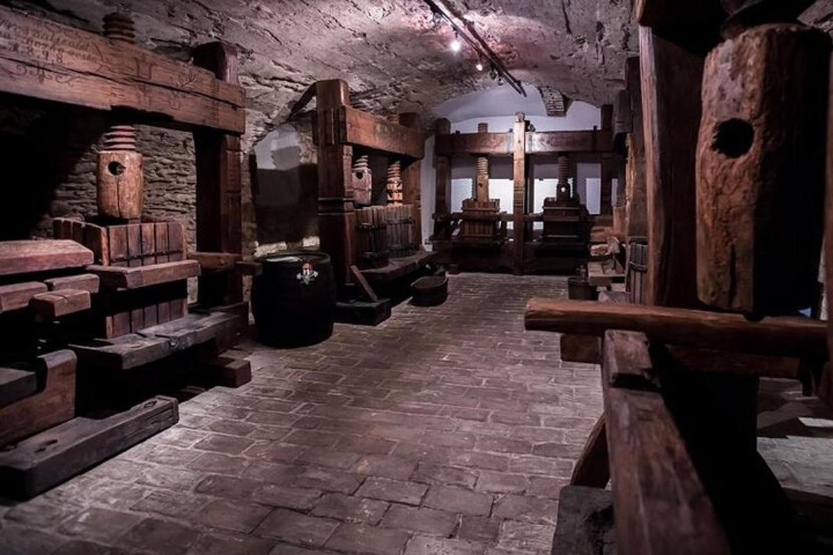 a large room with a stone floor and a room with logs