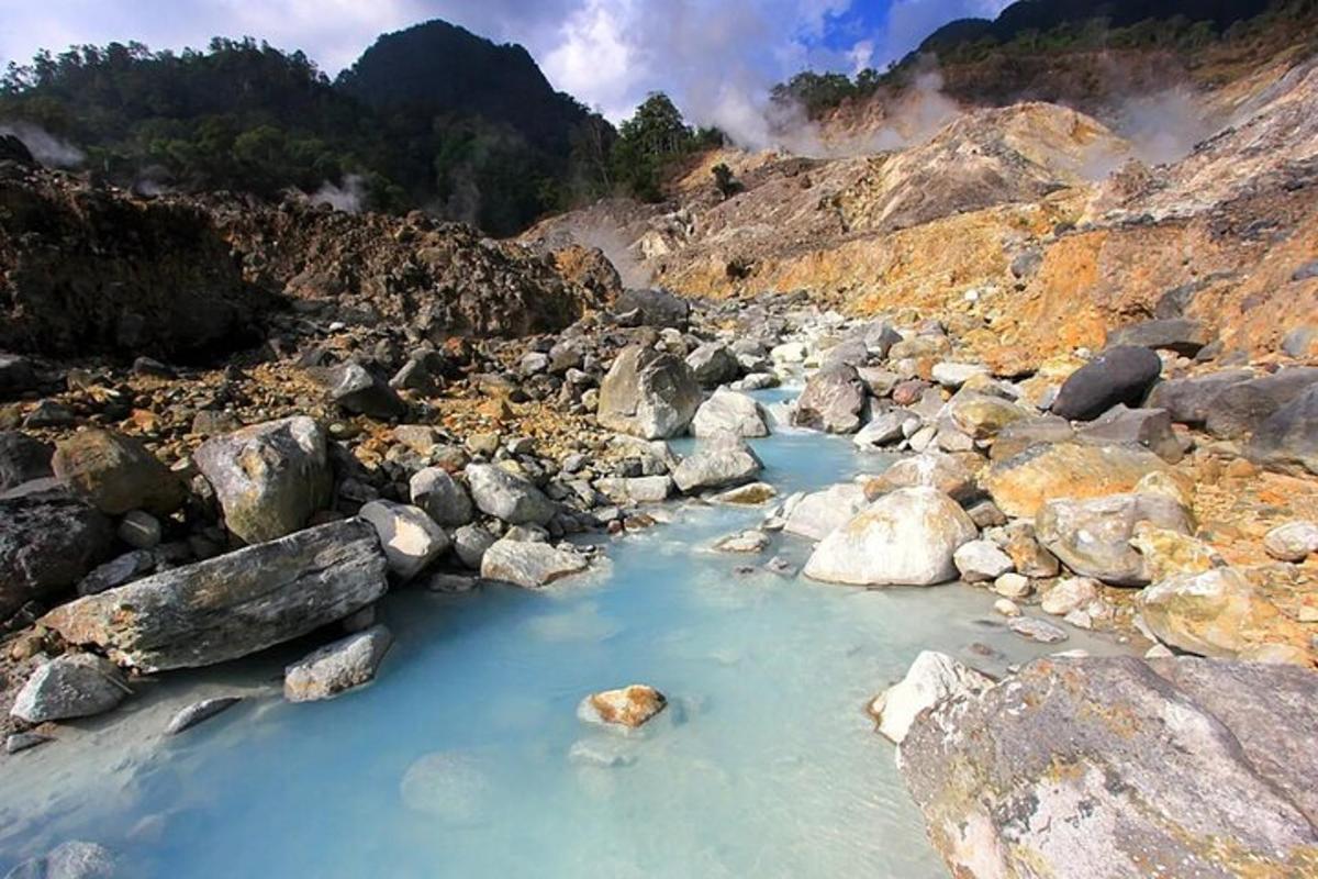 a rocky mountain with a pool of water and rocks