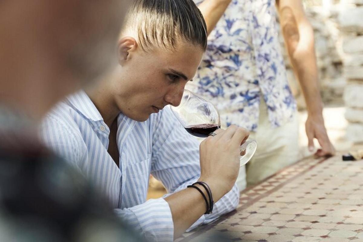 a woman drinking a glass of red wine