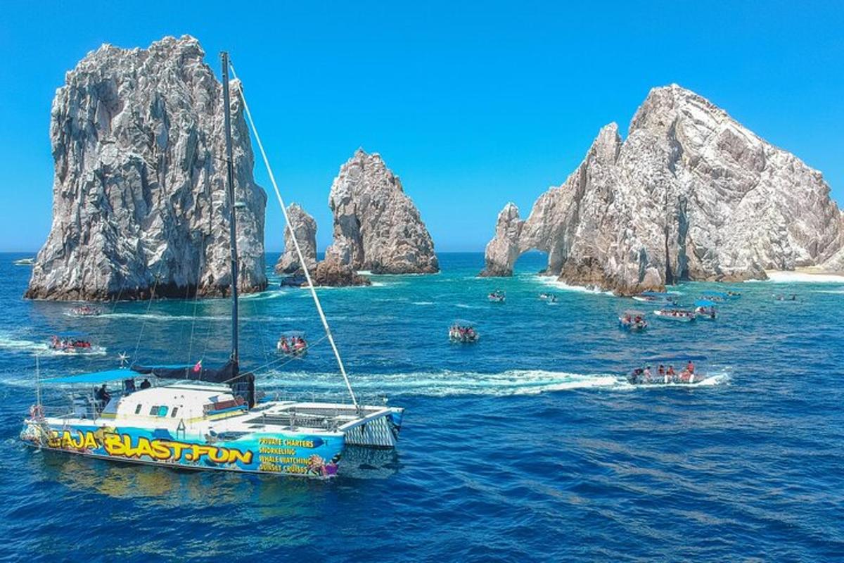 a boat in the water next to some rocks