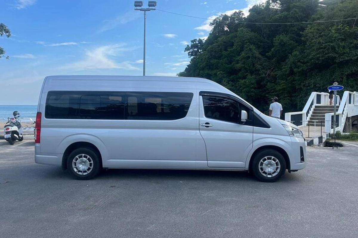 a white van parked in a parking lot near the ocean