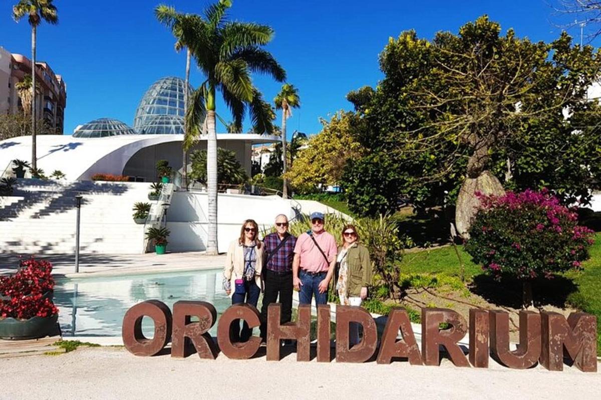 a group of people standing in front of a sign