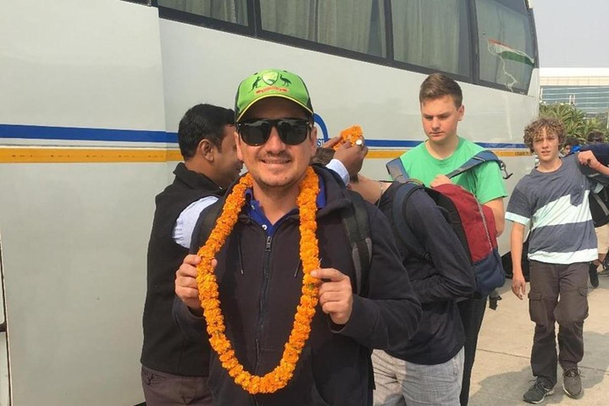 Un hombre que lleva una guirnalda naranja alrededor del cuello.