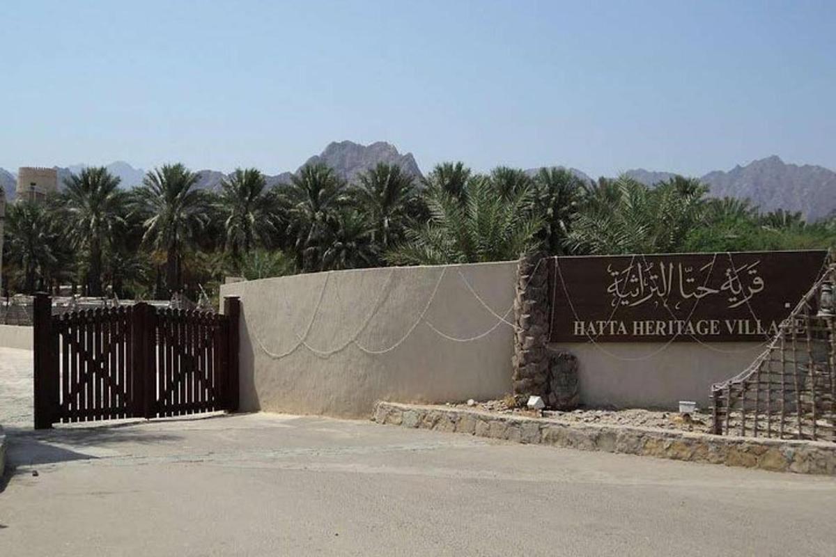 a sign for a skate park with palm trees in the background